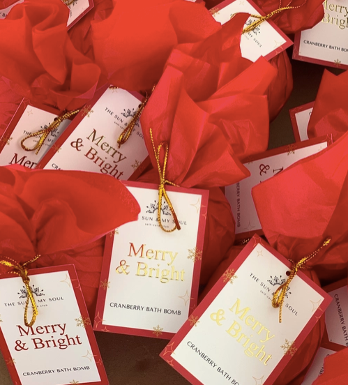 Red Christmas gift with 'Merry & Bright' labels, bath bomb gift