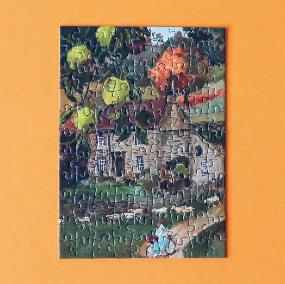 Jigsaw puzzle with a partially completed scene on an orange background