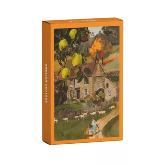 PuzzlePackaging with a scenic illustration of a cottage and people on a path, featuring an orange border.