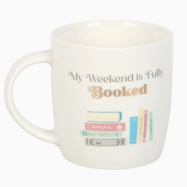 White mug with 'My Weekend is Fully Booked' text and book illustrations on a white background