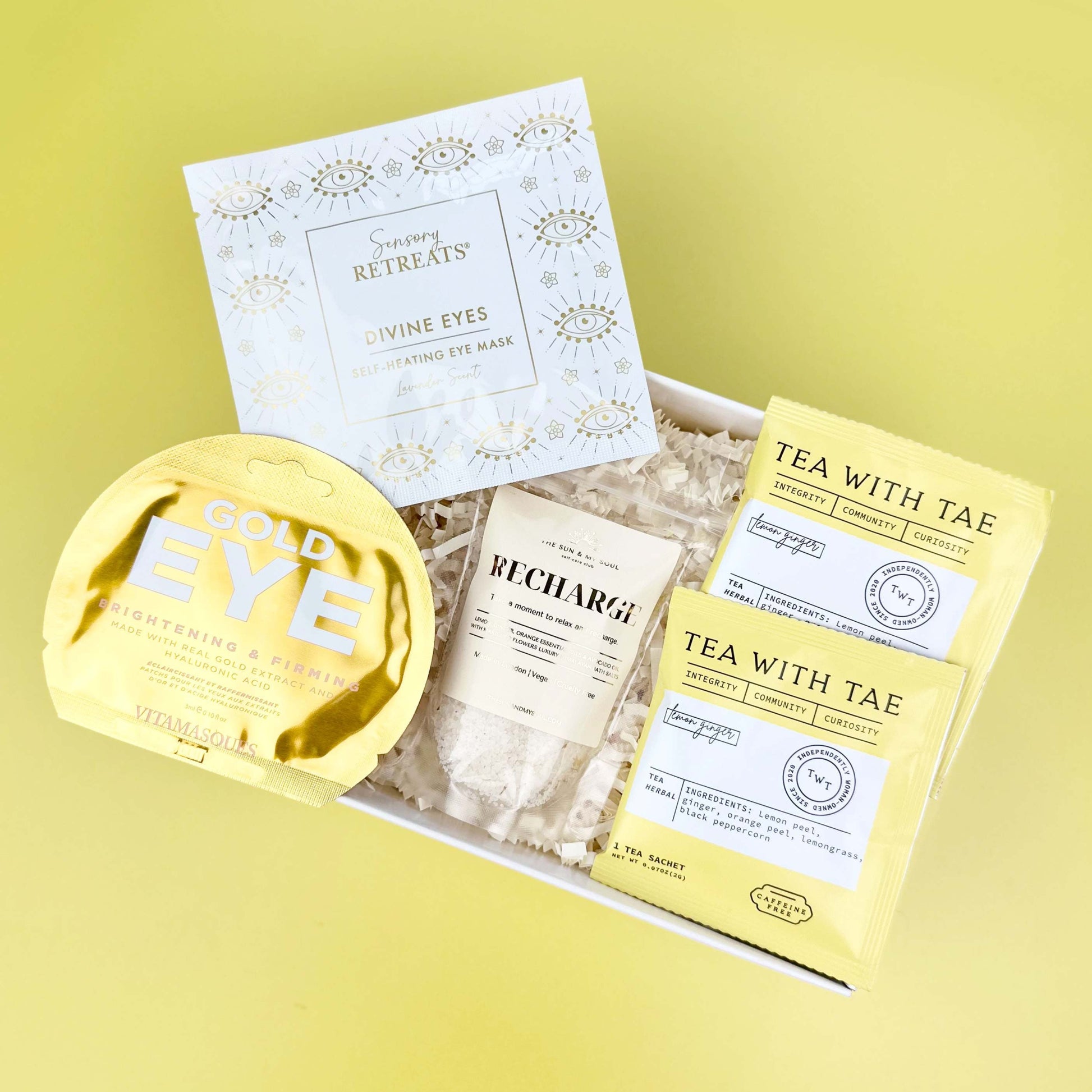 Packaged tea products with 'Gold Eye' and 'Tea with Tae' branding on a yellow background