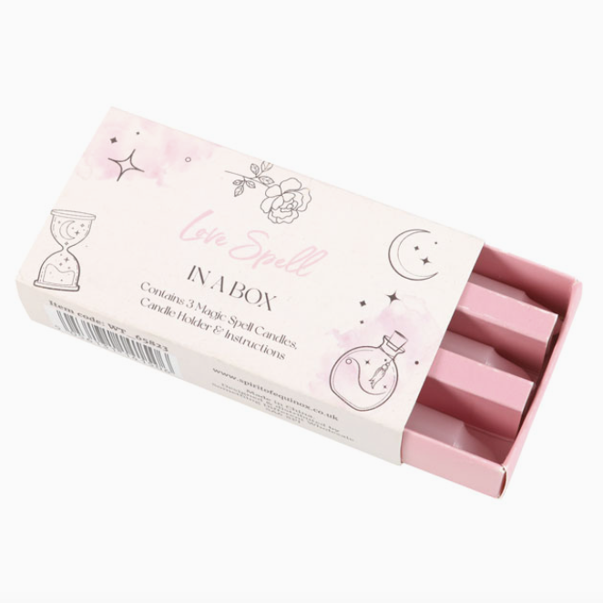 Pink candle set with packaging labeled 'Love Spell' on a white background