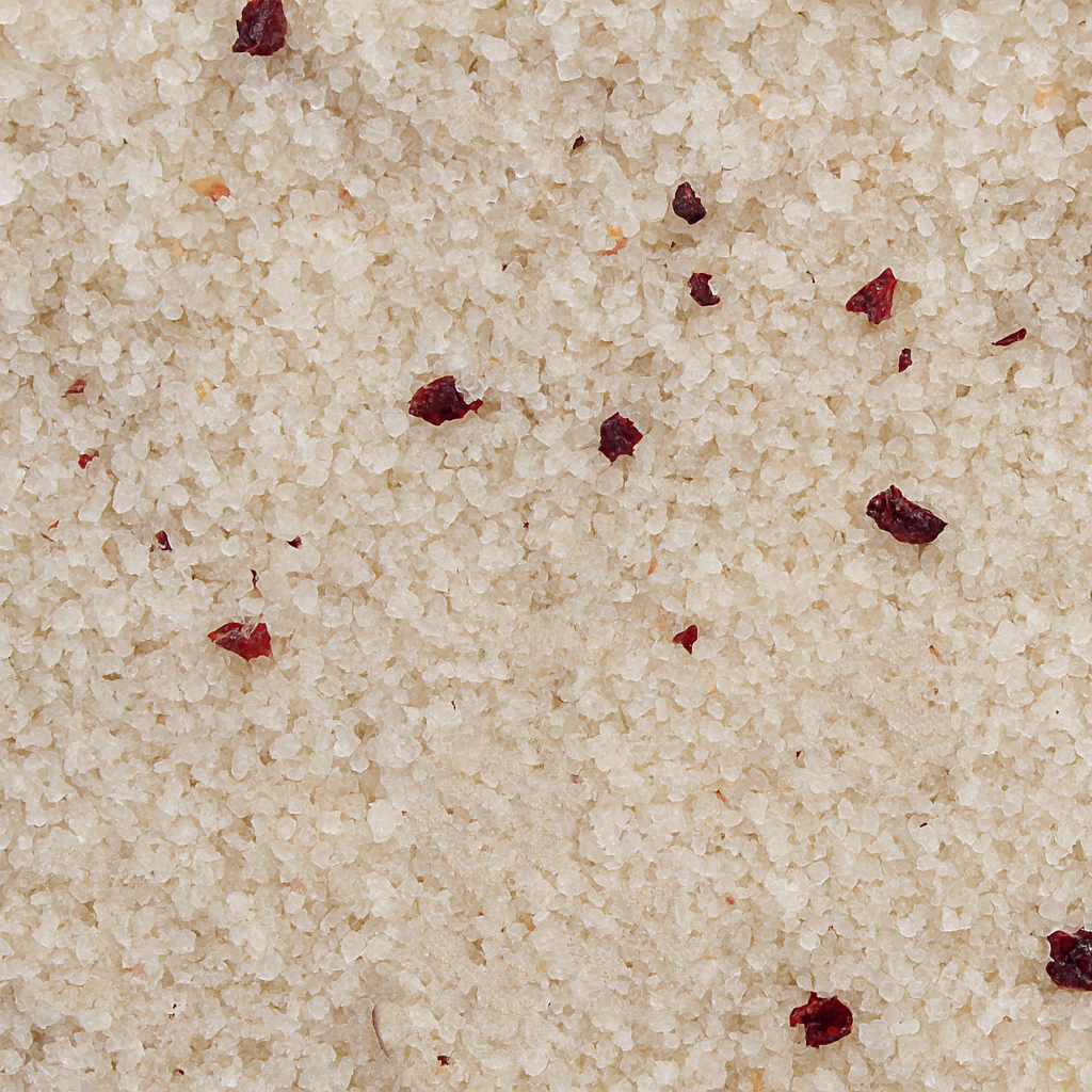 Close-up of beige sand with small red particles