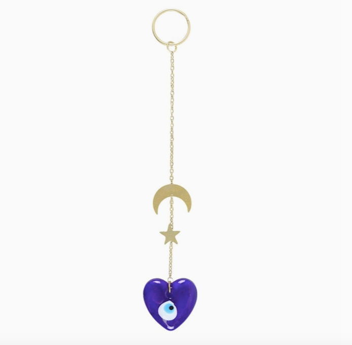 Blue heart-shaped decor with gold chain, moon, and star on a white background