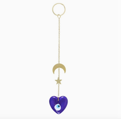 Blue heart-shaped decor with gold chain, moon, and star on a white background