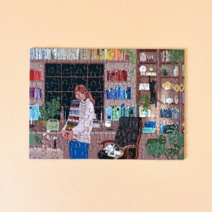 mini puzzle of a person in a room with books and plants on a beige background