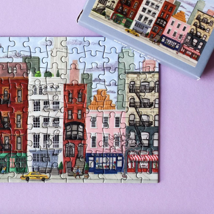 Jigsaw puzzle with colorful buildings on a purple background