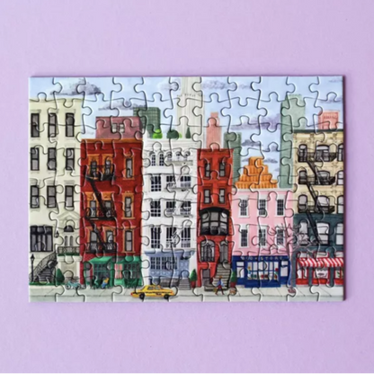 Jigsaw puzzle with a colorful cityscape design on a purple background