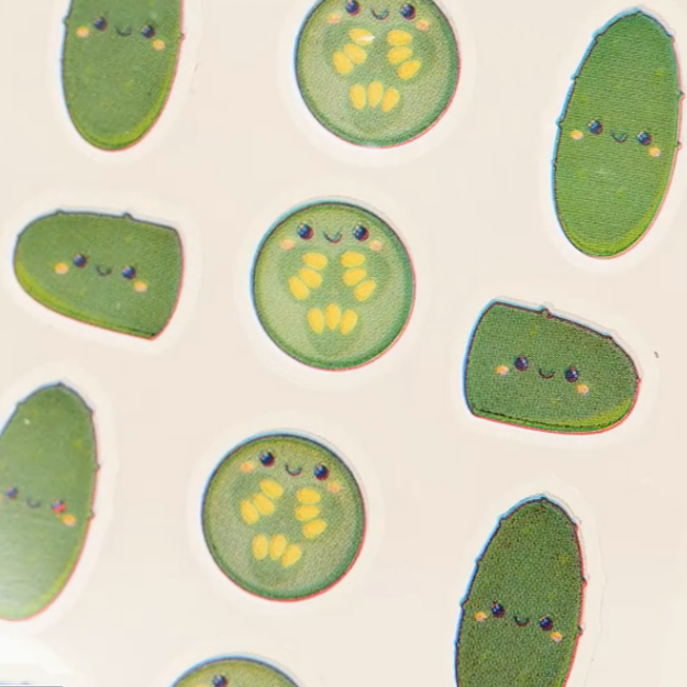 Illustrations of green pickles with smiling faces on a beige background