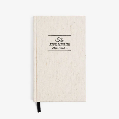 Beige journal with 'The Five Minute Journal' text on a white background